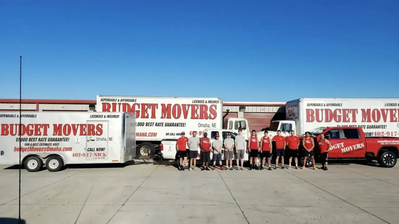 Budget Movers Omaha team standing in front of fleet of moving trucks